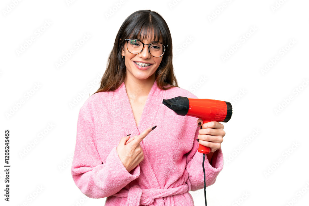 Young caucasian man holding a hairdryer over isolated chroma key background and pointing it Young caucasian man holding a hairdryer over isolated chroma key background and pointing it