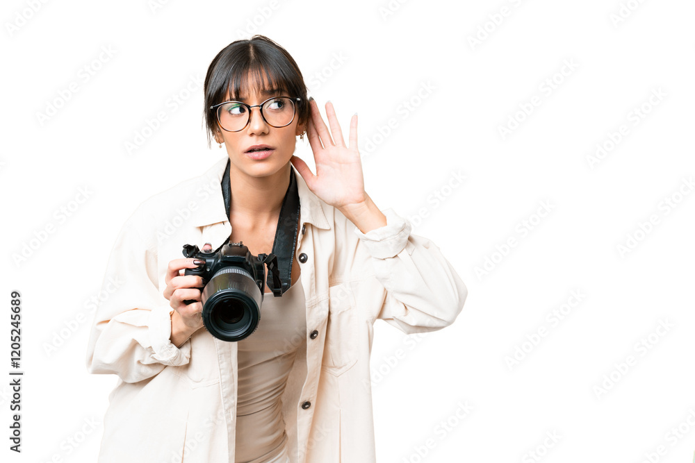 Young photographer caucasian woman over isolated chroma key background listening to something by putting hand on the ear Young photographer caucasian woman over isolated chroma key background listening to something by putting hand on the ear