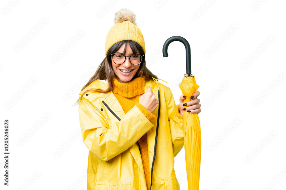 Young caucasian woman with rainproof coat and umbrella over isolated chroma key background celebrating a victory Young caucasian woman with rainproof coat and umbrella over isolated chroma key background celebrating a victory