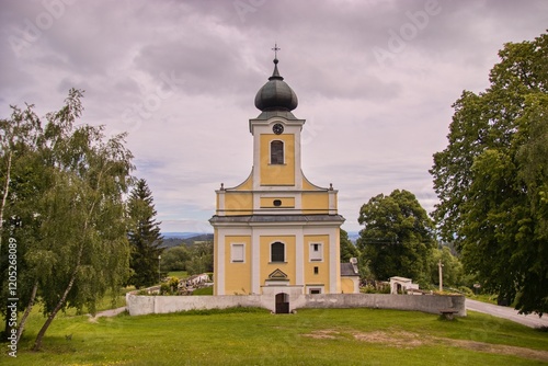 Obraz na płótnie A front view of Church of Saint Adalbert in village Lsteni, Czech republic w salonie