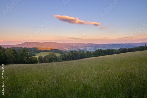 A beautiful sunset with colorful sky in the mountains at Sumava national park, Czech republic photo