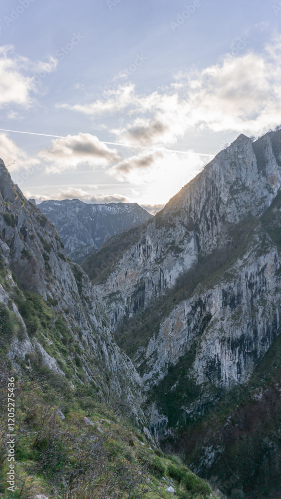 Mountain sunset over a canyon on a partially covered day Mountain sunset over a canyon on a partially covered day