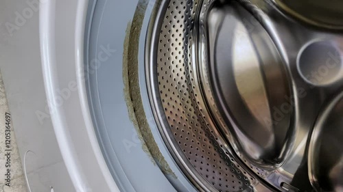 Dirty moldy rubber seal of the washing machine. Washing machine maintenance.