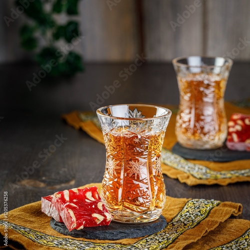 Azerbaijani black tea in armudu tea glass. Atmosphere of Baku and Eastern traditions. Oriental cuisine. Cozy atmosphere in the caucasus cafe.