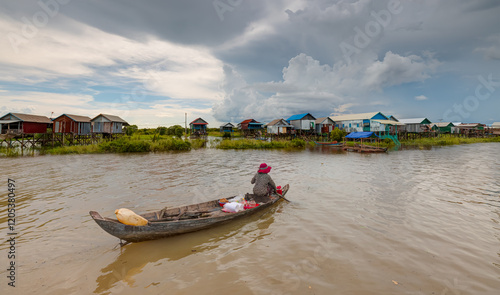 Tonle Sap lake, Siem reap Province, Cambodia. Fisherman in his boat, Floating village of Kompong Phluk, Cambodia.