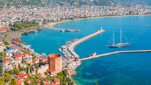 Fototapeta Naklejka Na Ścianę i Meble -  Ariel view of Alanya harbor from Alanya peninsula,  Black gulet anchored at the Mediterranean sea - Alanya, Antalya