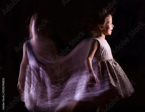 Fényképezés A girl in a dress in motion with a slow shutter speed