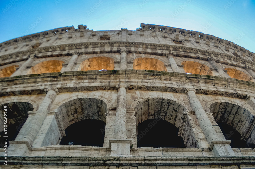 Obraz premium Iconic View of the Colosseum in Rome, Italy Ancient Architecture and History,The majestic Colosseum in Rome, Italy, stands as a symbol of ancient Roman engineering and cultural grandeur