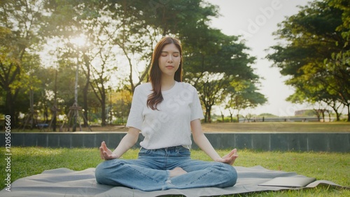 Free Download Beautiful Attractive Asian woman practice yoga in the sunny park, calm and breathing, Relaxed woman breathing fresh air in a green forest. Mental Health wellbeing or calm exercise. - GFXLoad