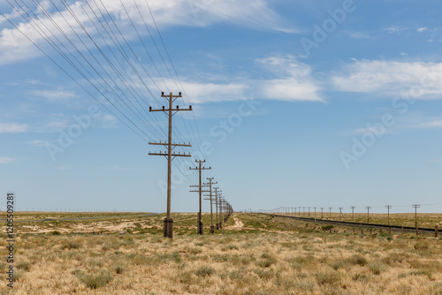 Electric and communication lines alongside railway in Mangystau Region, Kazakhstan