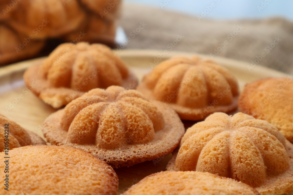 Side view Thai egg cake with or as it is known in Thai, Khanom Khai Made by baking. Similar to French Madeleines Side view Thai egg cake with or as it is known in Thai, Khanom Khai Made by baking. Similar to French Madeleines