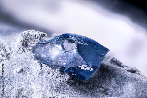 Benitoite blue crystal. Specimen from Gem mine, San Benito Co., California, USA. macro photography detail texture background. close-up mineral crystal unpolished semi-precious gemstone
