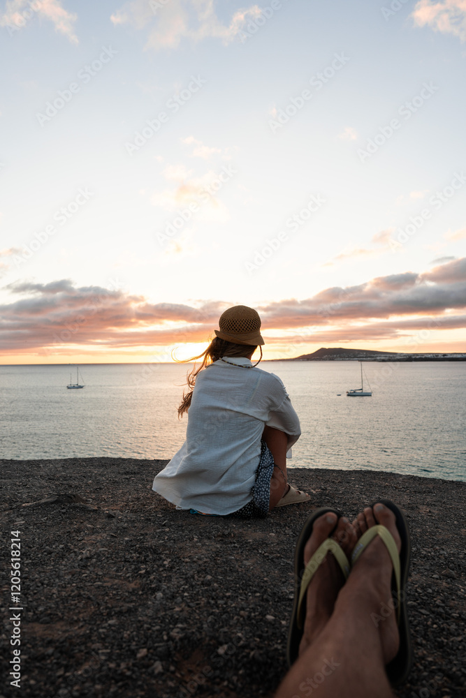Woman on a sunset view from the shore with a relaxed individual enjoying nature Woman on a sunset view from the shore with a relaxed individual enjoying nature