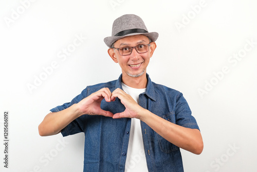 Happy Asian Man smiling with love sign or heart shape with hands on his chest, health concept
 photo