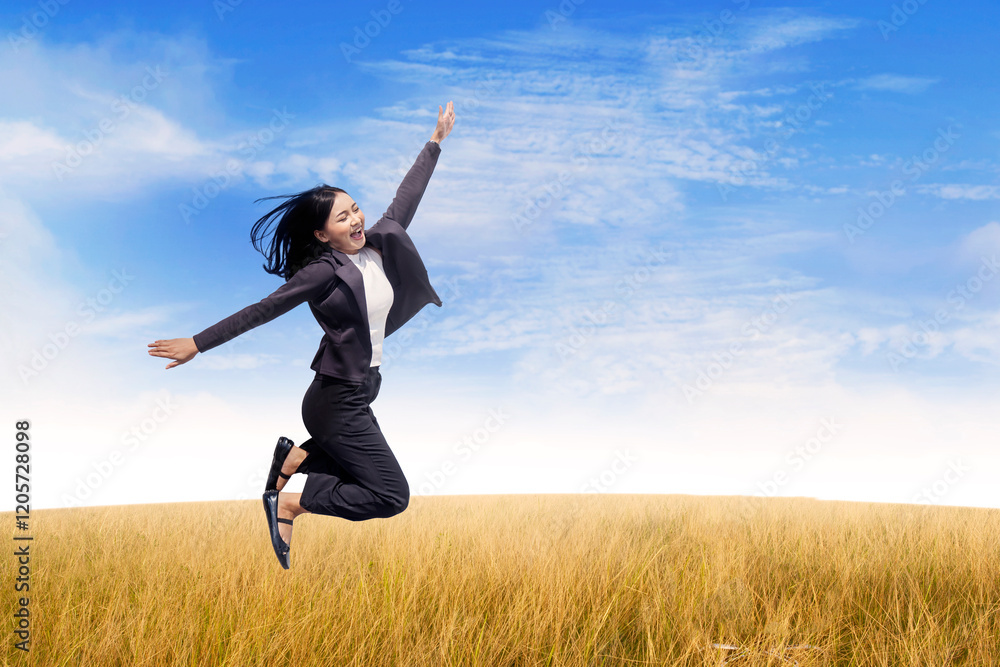 Businesswoman Jumping in a Field with a Bright Sky Background Businesswoman Jumping in a Field with a Bright Sky Background