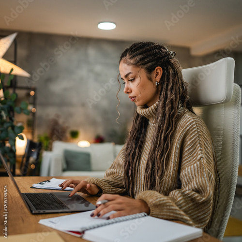 adult woman coiffure work on laptop and clipboard at home photo