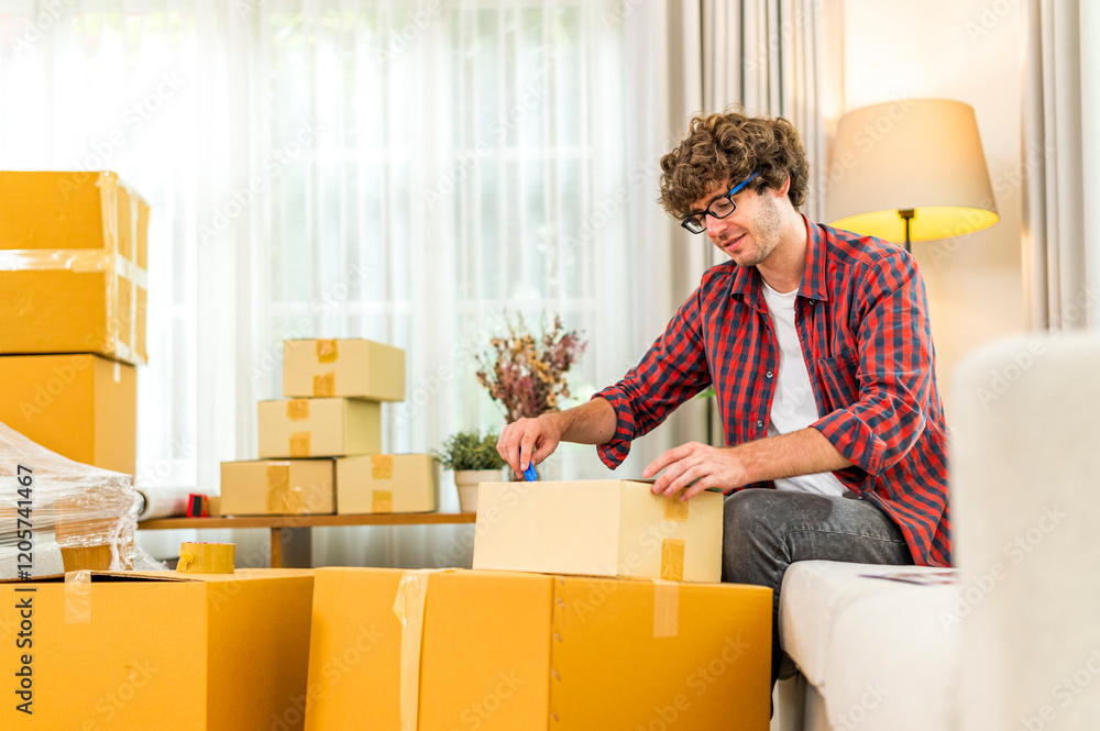 Happy smile young man carrying and unload cardboard box at moving into a new house, new apartment, new home - Moving house and Delivery