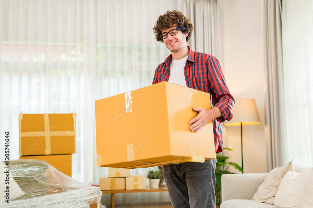 Happy smile young man carrying and load cardboard box at moving into a new house, new apartment, new home - Moving house and Delivery