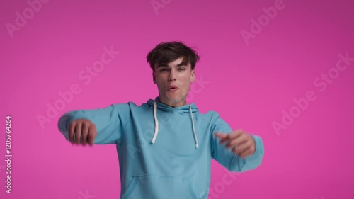 excited casual man in blue sweater moving his arms while pretending to explode at the climax