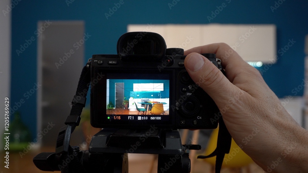 Real estate photographer taking pictures and videos at house in apartment living room with professional camera - selling home with real estate agency and home staging indoor home design