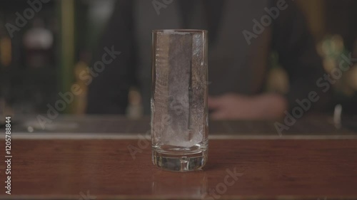 Close-up of a bartender preparing a cocktail with precision and skill, mixing ingredients in a modern bar setting