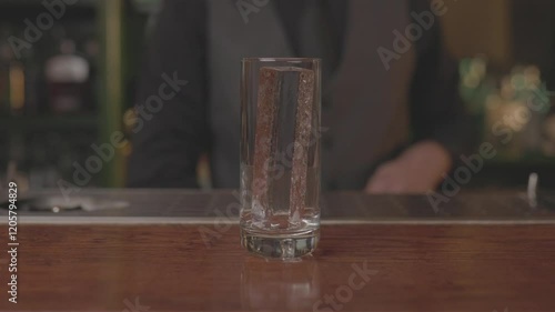 Close-up of a bartender preparing a cocktail with precision and skill, mixing ingredients in a modern bar setting