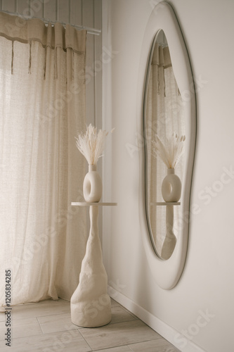 Beautiful light beige interior with curved mirror in wooden frame in japandi and wawabi sabi style, cozy home concept