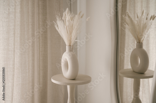 Obraz na płótnie Beautiful light beige interior with curved mirror in wooden frame in japandi and wawabi sabi style, cozy home concept w salonie