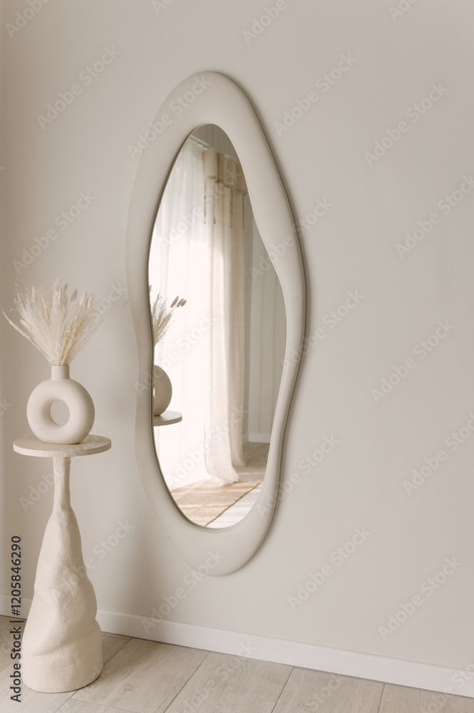 Beautiful light beige interior with curved mirror in wooden frame in japandi and wawabi sabi style, cozy home concept