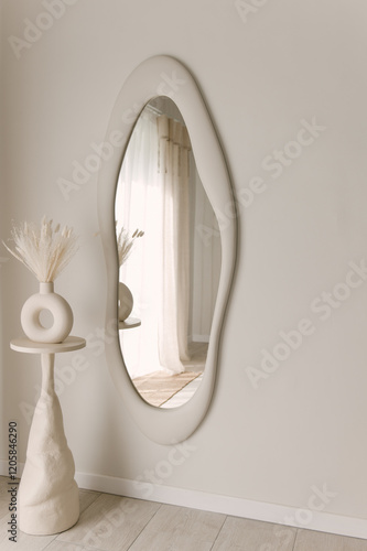 Obraz na płótnie Beautiful light beige interior with curved mirror in wooden frame in japandi and wawabi sabi style, cozy home concept w salonie