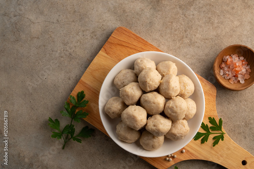 Uncooked Thai Pork meatballs on white plate.Top view with copy space. photo