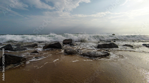 Beach with red sand, red rocks, and a dramatic sky in Congo Town, Monrovia, Liberia