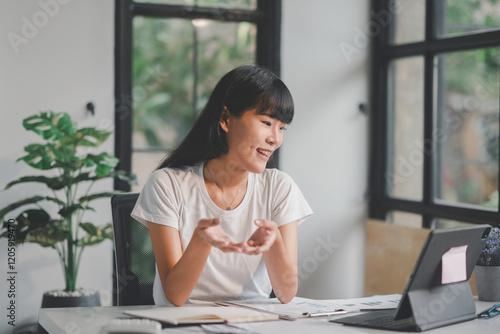 Free Download Young professional explaining financial charts during a video call in a modern office - GFXLoad