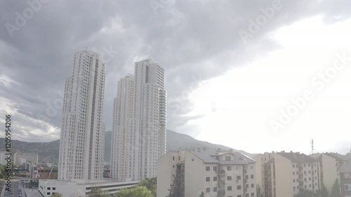 Right-to-left drone shot of Cevahir Towers, the tallest buildings in Skopje, showcasing modern architecture and the surrounding urban area