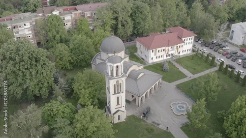 Circular aerial shot of a church in the city of Skopje, showcasing its architecture and surrounding urban landscape