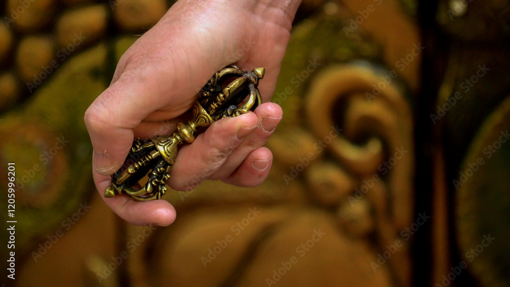 Hand holding tibetan vajra ghanta dorje drilbu ritual object