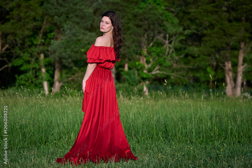 Sexy woman in beautiful red dress stands in open field - fashion Sexy woman in beautiful red dress stands in open field - fashion