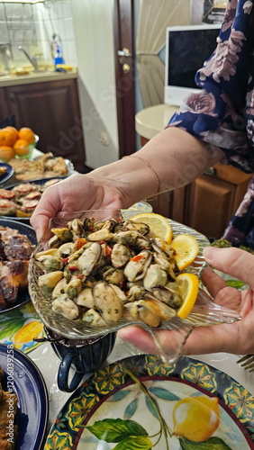 Female hands holding a plate with mussels and lemo photo