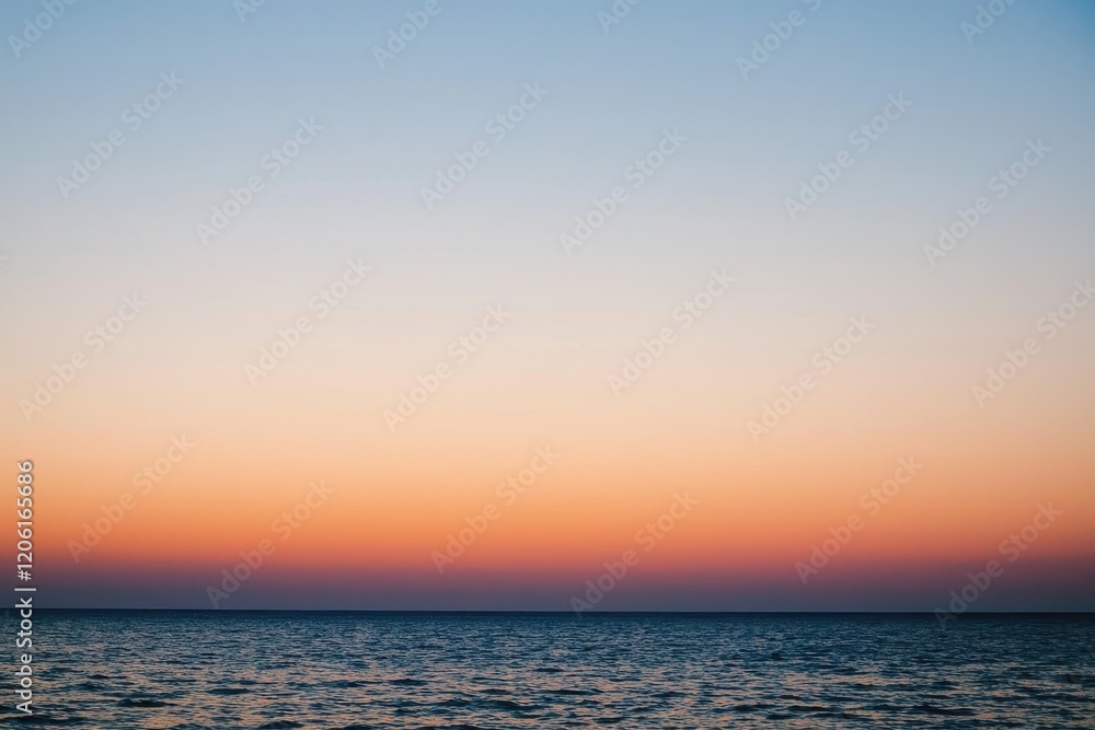 Obraz premium Sunset Gradient: A sky transitioning from deep orange to soft pink, with the horizon fading into a calm, dusky blue