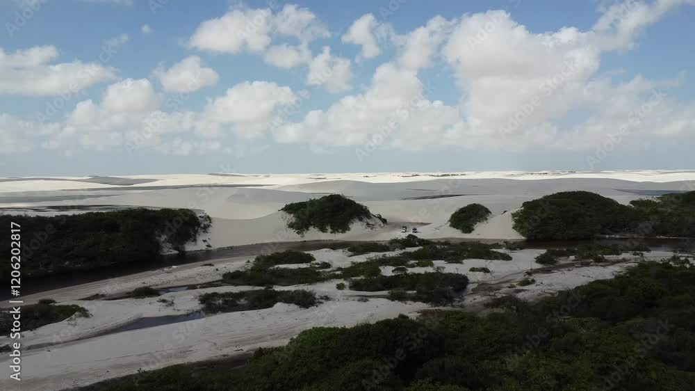 Drone image taken in a place with many white sand dunes and lagoons, as well as lots of vegetation Drone image taken in a place with many white sand dunes and lagoons, as well as lots of vegetation