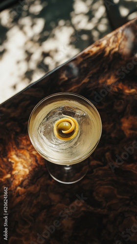 Classic cocktail with lemon twist and olive served in a dimly lit bar