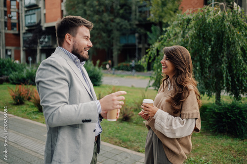 Two business colleagues enjoying coffee break and having a conversation photo