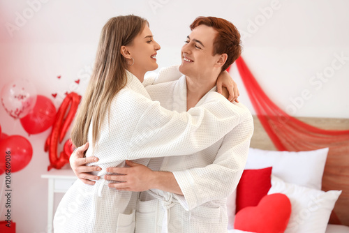 Young couple hugging in bed...