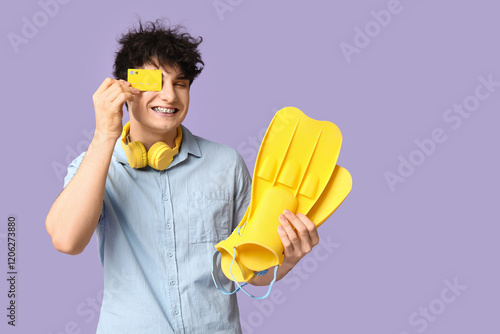 Young man in headphones hol...
