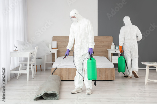 Male workers in hazmat suit...