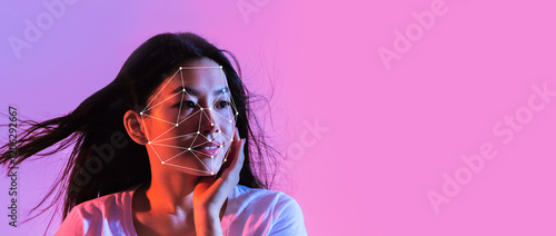 Photography A woman models facial recognition technology with a highlighted facial mapping design