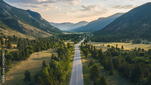 A bird's-eye view of a serene valley road, flanked by tall greenery, with majestic mountains in the background. Majestic Valley. Illustration photo