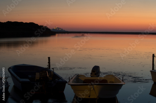 boat at sunset Mouth of the Coghinas river in Valledoria, a few kilometers from Castelsardo. Sassari, Sardinia. Italy photo