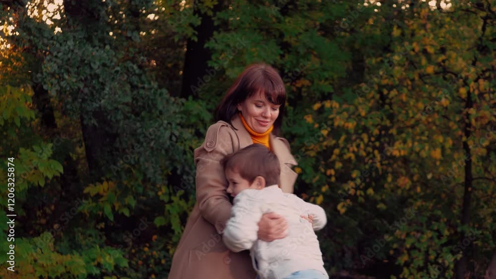Boy runs to meet mother sharing embrace. Boy rushes toward mother with excitement and envelops in embrace. Boy eagerly runs to mother embracing with deep affection amidst vibrant autumn nature Boy runs to meet mother sharing embrace. Boy rushes toward mother with excitement and envelops in embrace. Boy eagerly runs to mother embracing with deep affection amidst vibrant autumn nature