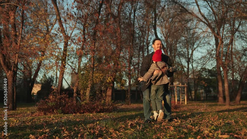 Bearded dad and daughter treasure time spending together in nature. Dad and daughter smile sincerely meeting for long-awaited walk. Young dad lifts active daughter in arms during pleasant stroll Bearded dad and daughter treasure time spending together in nature. Dad and daughter smile sincerely meeting for long-awaited walk. Young dad lifts active daughter in arms during pleasant stroll